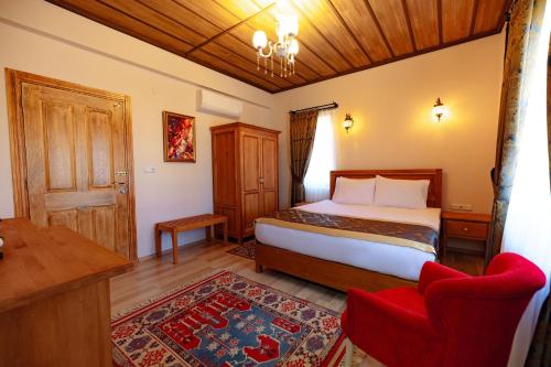 a bedroom with a bed and a table and chairs at Cappadocia Villa Comfort in Nevsehir