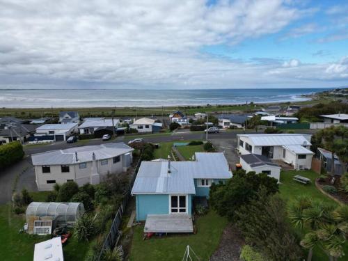 an aerial view of a small town with houses and the ocean at Beach Bliss Retreat in Riverton