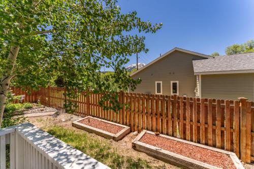 a fence with three raised garden beds in front of a house at 1101 Mesa Drive: 2 in Silverthorne