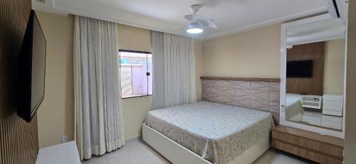 Ένα ή περισσότερα κρεβάτια σε δωμάτιο στο Casa Temporada Paraíso