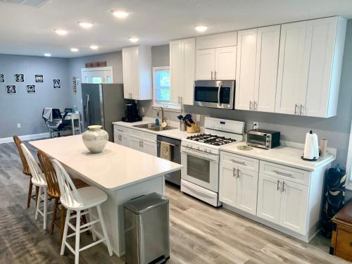 a kitchen with white cabinets and a table with chairs at Getaway Clubhouse in Winter Haven