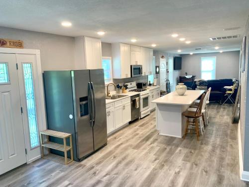 a kitchen with a stainless steel refrigerator and a table at Getaway Clubhouse in Winter Haven