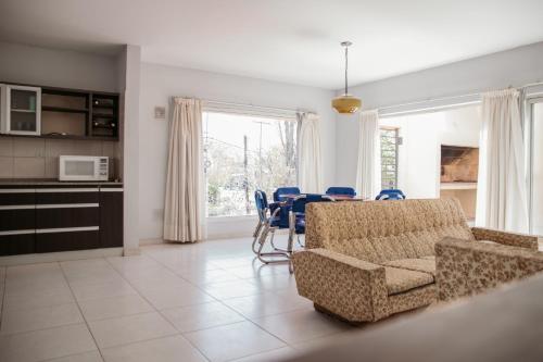 a living room with a table and chairs and a kitchen at Ramas House in San Rafael