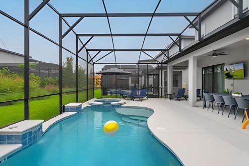 a swimming pool with a ball in the middle of it at Paradiso Grande Luxury w/ Cinema, Games & Pool in Orlando