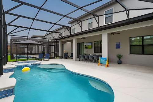 an indoor swimming pool with a glass ceiling at Paradiso Grande Luxury w/ Cinema, Games & Pool in Orlando