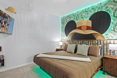 a bedroom with a bed with a large headboard at Paradiso Grande Luxury w/ Cinema, Games & Pool in Orlando
