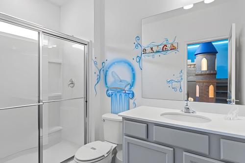 a bathroom with a toilet and a sink and a shower at Paradiso Grande Luxury w/ Cinema, Games & Pool in Orlando