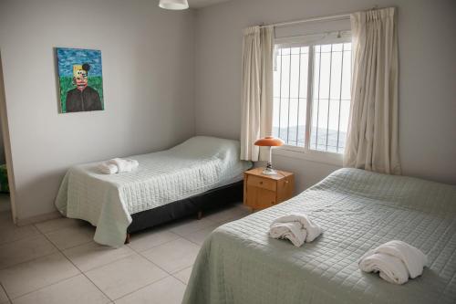 a bedroom with two beds and a window at Ramas House in San Rafael