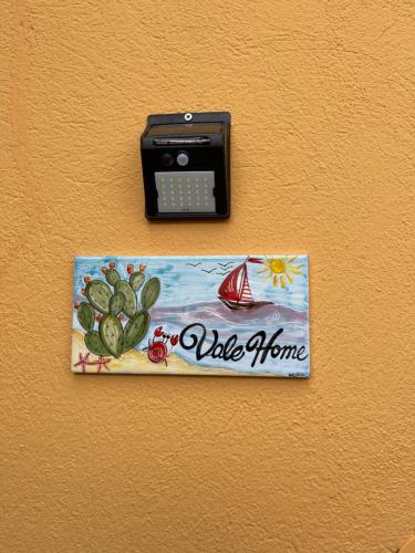 a phone on a wall with a sign on it at Valehome Villasimius in Villasimius