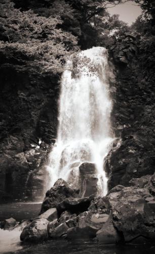 a black and white photo of a waterfall at やまおう　宿＆カフェ in Nikaho