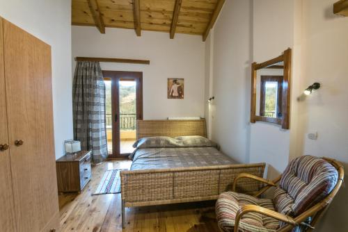 a bedroom with a bed and a chair at Athina's House in Alónai