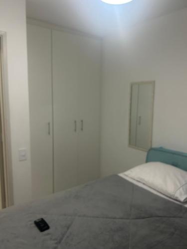 a bedroom with a bed with a remote control on it at Perto Hospital AC Camargo Metro Vergueiro - feito retrofit 2024 in Sao Paulo