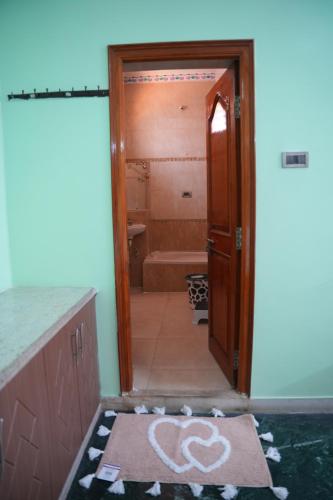 a bathroom with a shower and a door leading to a tub at The HR STAY INN TIRUPATI - LUXURY HOMESTAY - NEAR ALIPIRI BUS STAND AND KAPILATEERTHAM - 24 HRS HOT WATER-150 MBPS SPEED FREE WIFI & ALL OTT APPS in Tirupati