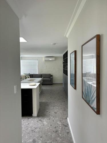 a living room with a couch and a table at Versatile summer beach house or cosy winter retreat! in Mandurah