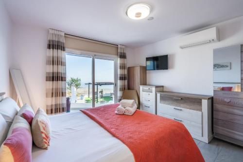a bedroom with a bed and a dresser and a window at El rinconcito with sea view in Los Menores