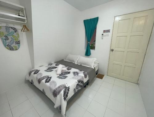 a bedroom with a bed in a room with a door at WIWI Village in Kemasik
