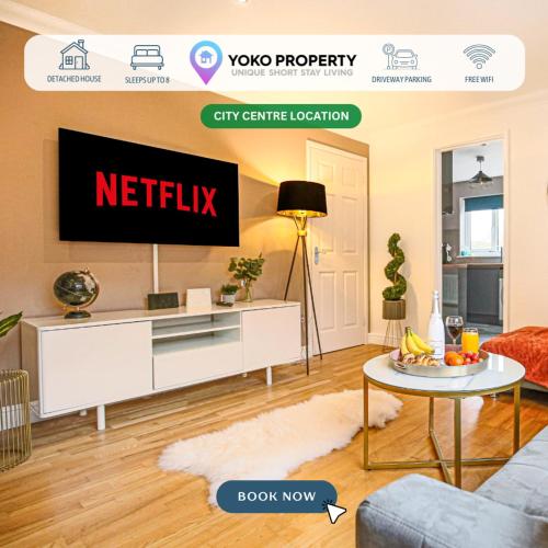 a living room with a tv on a wall at Detached House - City Centre Location - Free Parking, Garden, Smart TVs with Netflix by Yoko Property in Milton Keynes