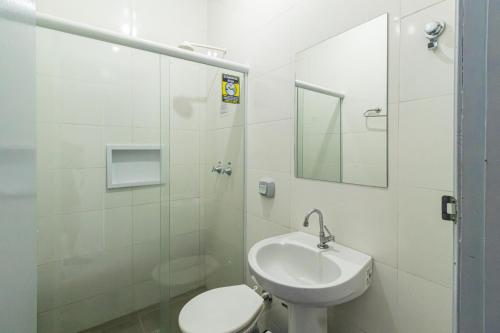a bathroom with a sink and a toilet and a shower at Euro Hotel in Ubiratã