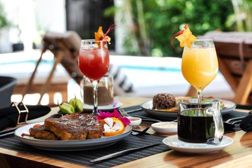 a table with plates of food and two drinks at La Prometida in Puerto Viejo