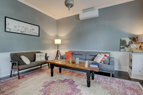a living room with a couch and a coffee table at Historic Home in the Heart of Elora in Elora