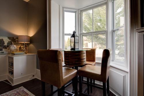 a dining room with a table and chairs and a window at Historic Home in the Heart of Elora in Elora