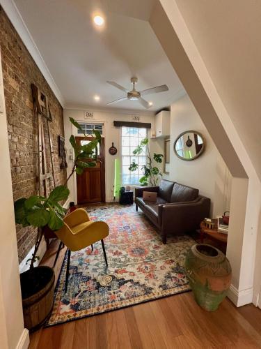 a living room with a couch and a rug at Casa Portuguesa in Sydney