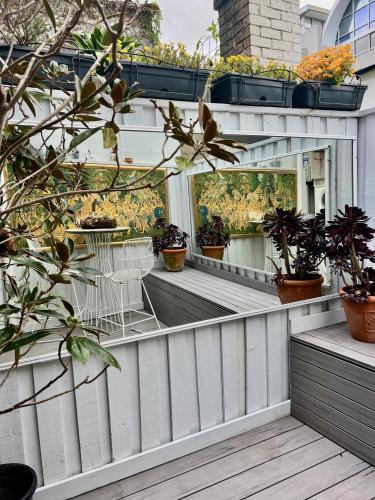 a mirror on the side of a house with potted plants at Casa Portuguesa in Sydney