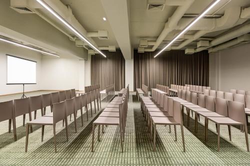 an empty lecture room with chairs and a podium at Holiday Inn Beja by IHG in Beja