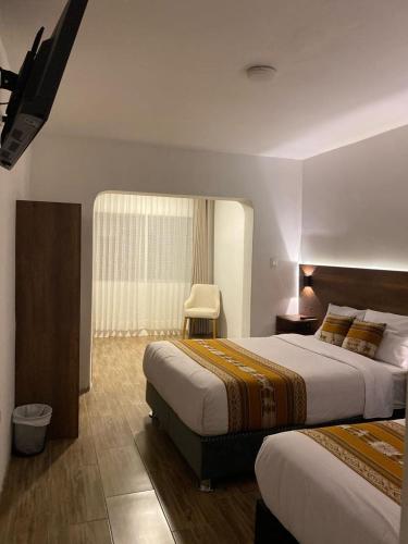 Ένα ή περισσότερα κρεβάτια σε δωμάτιο στο Hotel Rumi