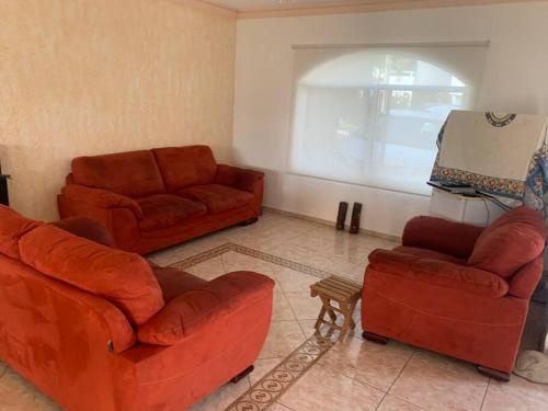 a living room with two couches and two chairs at Residencia con alberca privada y jacuzzi en Lomas de Cocoyoc in Oaxtepec