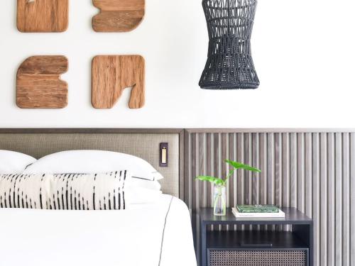 a bedroom with a bed and a vase on a table at Kimpton - Grand Roatan Resort and Spa in West Bay