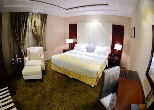 Pokój hotelowy z łóżkiem i krzesłem w obiekcie Al Ebreez Palace 3 w mieście Burajda