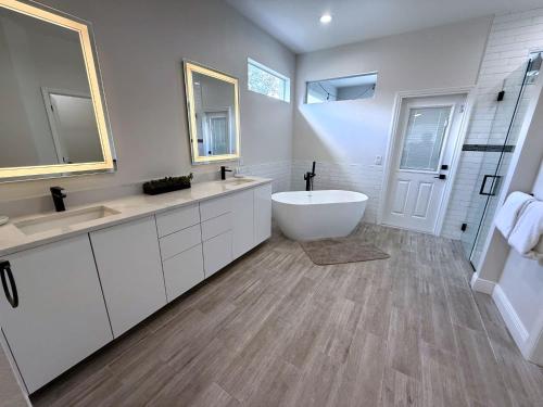 a bathroom with two sinks and a bath tub at Elite Forest Hills Villa - Southern Dunes - Golf Course Views in Haines City
