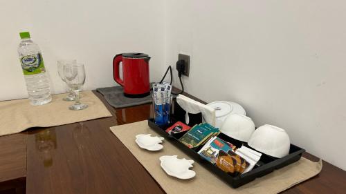 a table with a tray of food and a bottle of water at Boutique by Sa in Anuradhapura