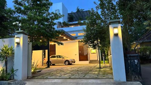 a car parked in the driveway of a house at Boutique by Sa in Anuradhapura