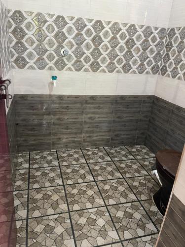 a bathroom with a shower with a toilet at Scott legacy apartment in Kulattūr