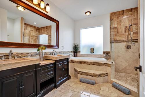 a bathroom with a tub and a sink and a shower at stunning waterfront villa in boca raton in Boca Raton