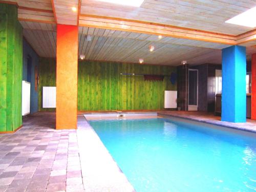 a swimming pool in a room with green walls at Lovely house with much luxury and comfort in Waimes