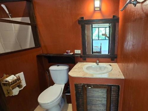 a bathroom with a toilet and a sink at Insda Wellness Resort in Chiang Mai