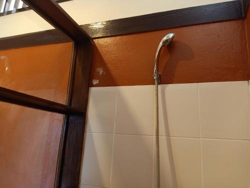 a shower in a bathroom with a shower head at Insda Wellness Resort in Chiang Mai