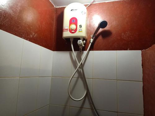 a blow dryer on a wall in a bathroom at Insda Wellness Resort in Chiang Mai