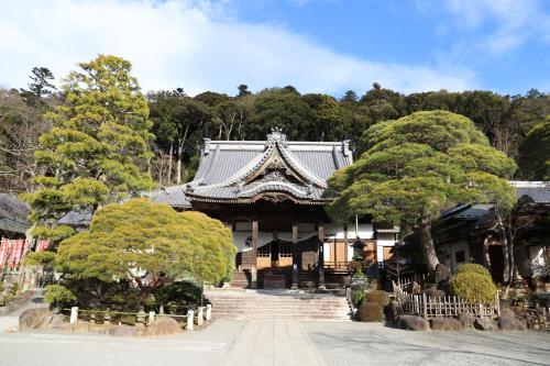 an asian style building with trees in front of it at Izu Marriott Hotel Shuzenji in Izu