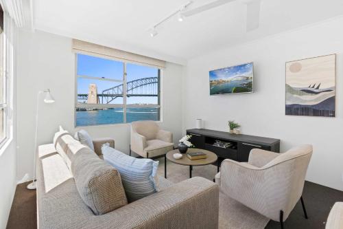 a living room with a couch and chairs and a table at Sydney Harbourside Apartment in Sydney