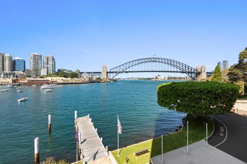 a view of a river with a bridge in the background at Sydney Harbourside Apartment in Sydney