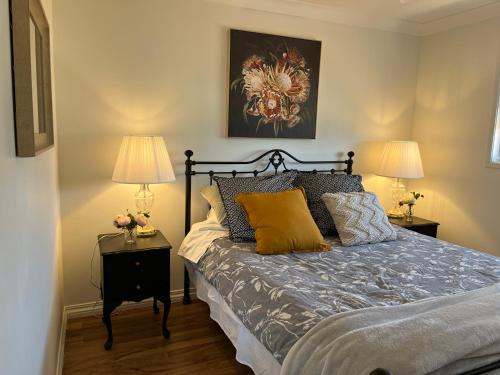 a bedroom with a bed with two lamps on tables at Wallawa on Hilltop in Ellesmere