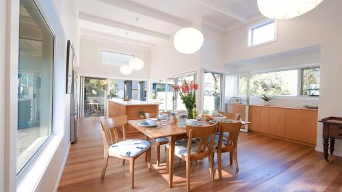 a kitchen and dining room with a table and chairs at Buwarla House in Currarong