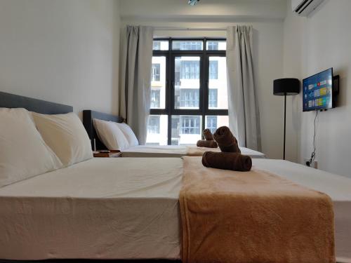 a teddy bear sitting on a bed in a bedroom at K Avenue Modern Style Studio (5 Mins to Airport) in Kota Kinabalu