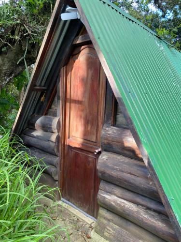 a door in the side of a small house at Cabañita del bosque de la cumbre de san Bartolo Milpas Altas in Guatemala