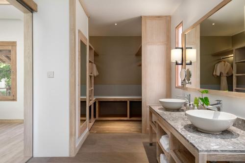 a bathroom with two sinks and a large mirror at SAii Phi Phi Island Village in Phi Phi Islands