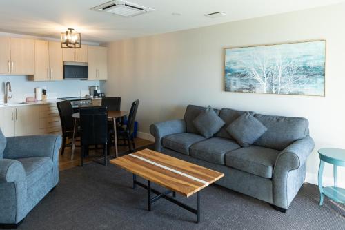 a living room with a couch and a table at Inn on Long Lake in Nanaimo